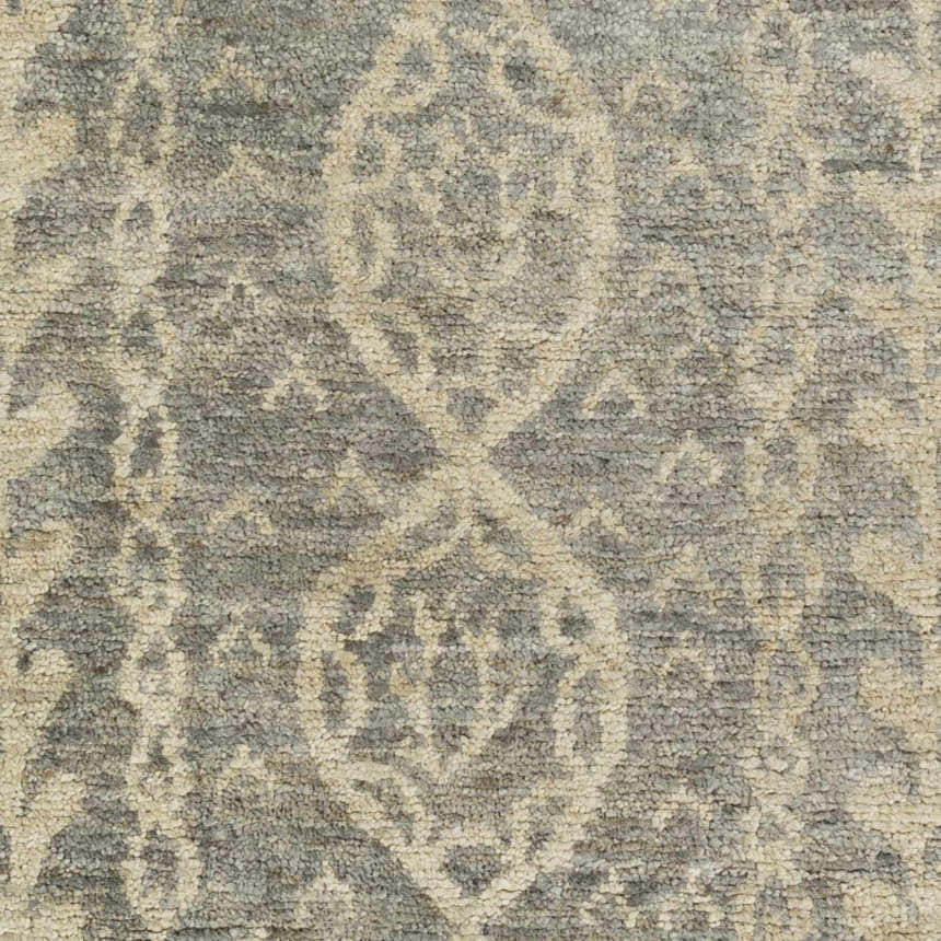 Close-up of the Sonnette Jute Rug showing its gray and ivory farmhouse pattern and hand-knotted texture. Swatch
