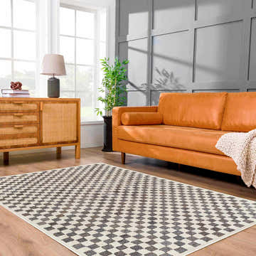 Living room scene with an orange sofa and Halen Taupe Checkered Area Rug on a wood floor. Roomscene-Rectangle