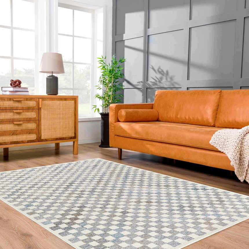Living room with Halen Gray Checkered Area Rug, wood floors, tan leather sofa, and wood cabinet. Modern style. Roomscene-Rectangle