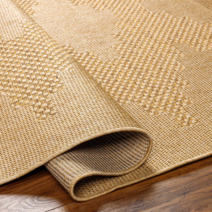 Close-up of the Colum Flatweave Faux Jute Rug. Tan and brown woven texture detail. Contemporary style rug. Fold