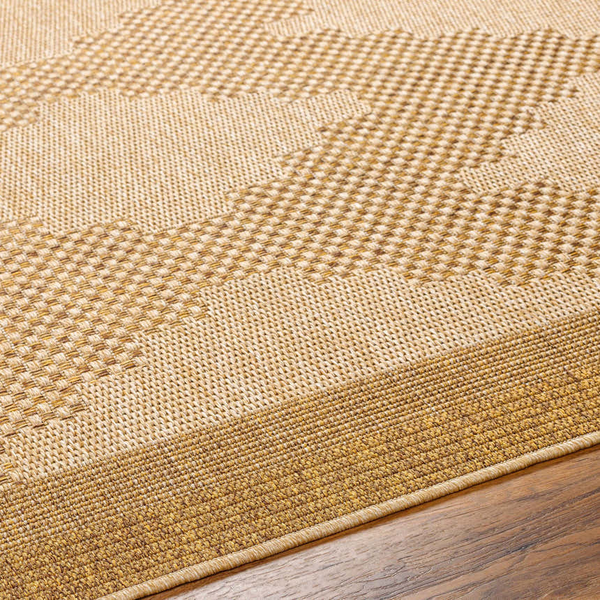 Close-up of the Colum Flatweave Faux Jute Rug. Tan, brown, and off-white woven texture detail. Contemporary style. Texture