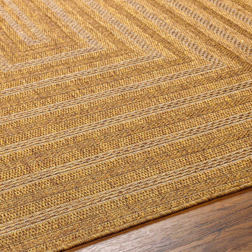 Close-up of the Dyami Flatweave Faux Jute Rug showing its camel and light brown hues, and woven texture. Texture