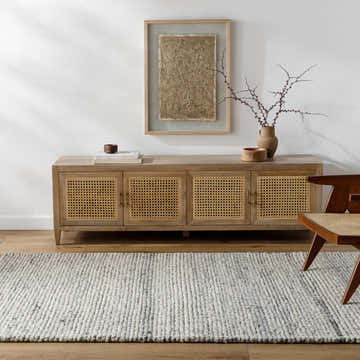 Living room scene with a light wood console table and the Olisa Cream & Gray Wool Area Rug on a wood floor. Roomscene-Rectangle