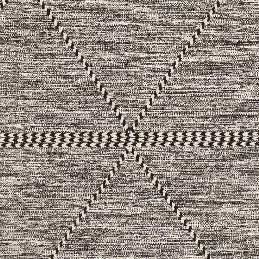Close-up of Spottswood Area Rug. Black and cream cotton rug with hand-woven geometric diamond and stripe pattern. Swatch