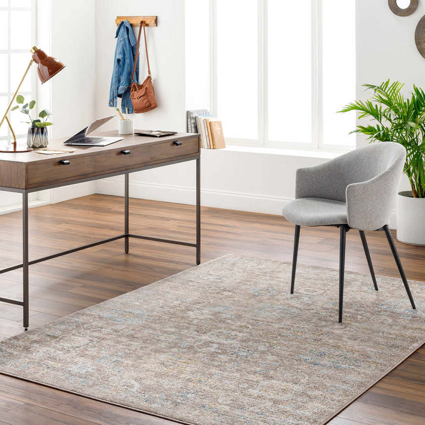 Home office with a Harim Light Brown Area Rug, wood desk, gray chair, and bright natural light. Roomscene-Rectangle