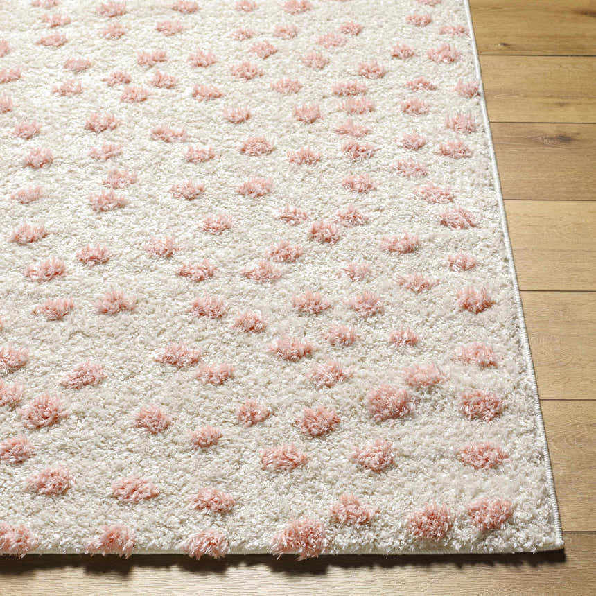 Close-up of the Bernt Beige Area Rug with a pale pink tufted dot pattern and soft, textured pile. Front