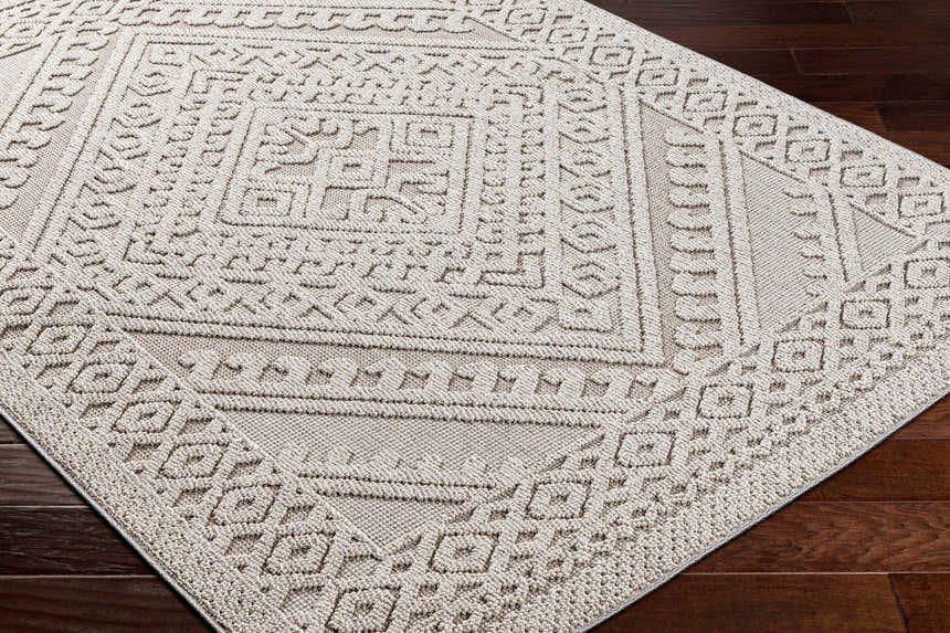Close-up of the Hibah Natural Gray Area Rug showing its contemporary geometric pattern and textured weave. Corner