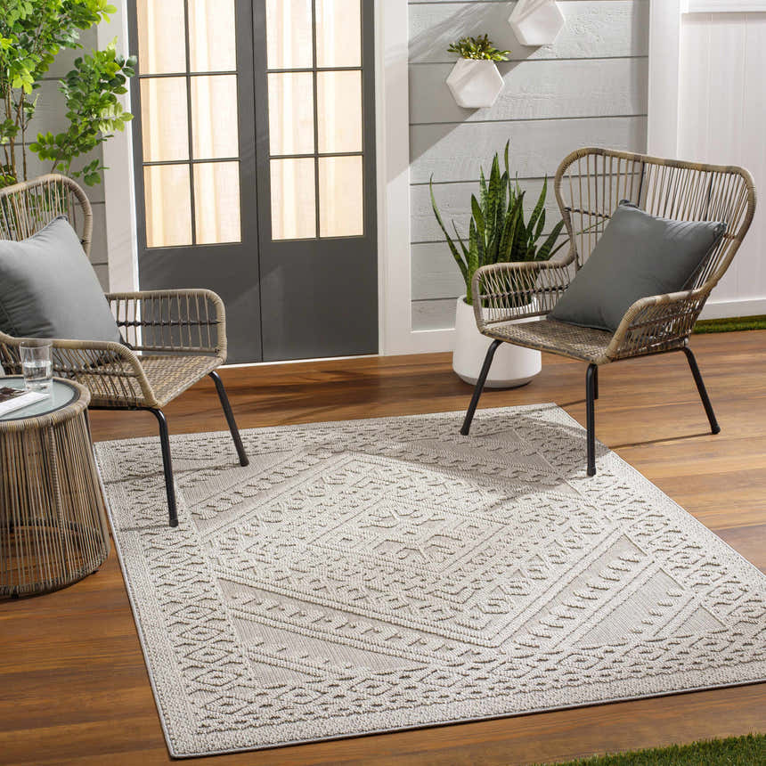 Patio scene with Hibah Natural Gray Area Rug, wicker chairs, wood floors, and gray accents. Roomscene-Rectangle