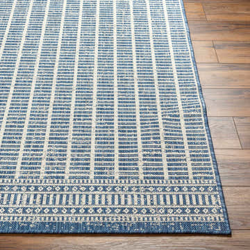 Close-up of the Amena Blue Area Rug showing its geometric pattern and blue and beige color palette. Front