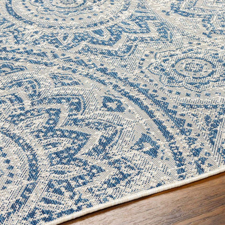 Close-up of the Ayala Blue Durable Rug showing its detailed traditional pattern and textured weave in arctic sky and stone. Texture