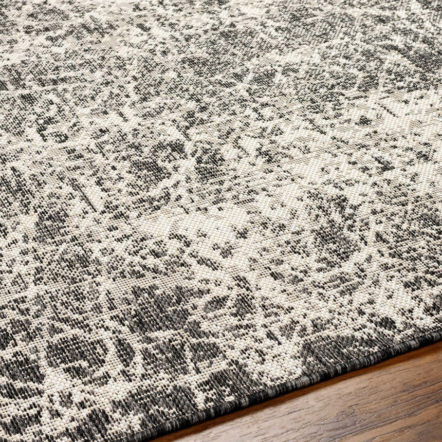 Close-up of the Katz Gray Area Rug, showcasing its beige and charcoal abstract pattern and woven texture. Texture