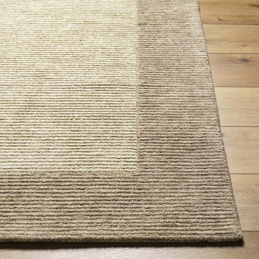 Close-up of the hand-tufted Amadi Area Rug. Neutral pearl and tan tones with a subtle striped design. 100% Wool. Front