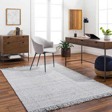 Light Blue Aron Area Rug in a bright home office with wood desk, gray chair, and hardwood floors. Contemporary, Scandinavian style. Roomscene-Rectangle