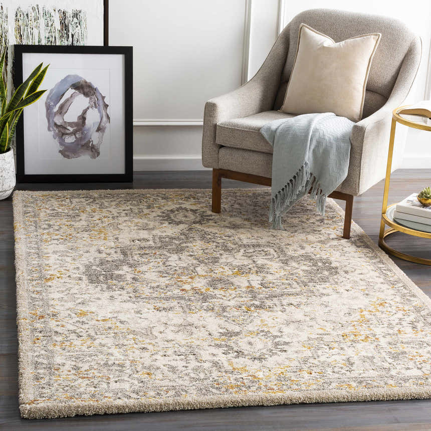 Living room scene with a Stockwell Thick Luxe Rug in ivory, gold, and gray under a chair and side table. Roomscene-Rectangle