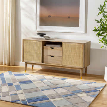 Living room scene with a light wood console table and the blue and gray Carla Area Rug. Roomscene-Rectangle