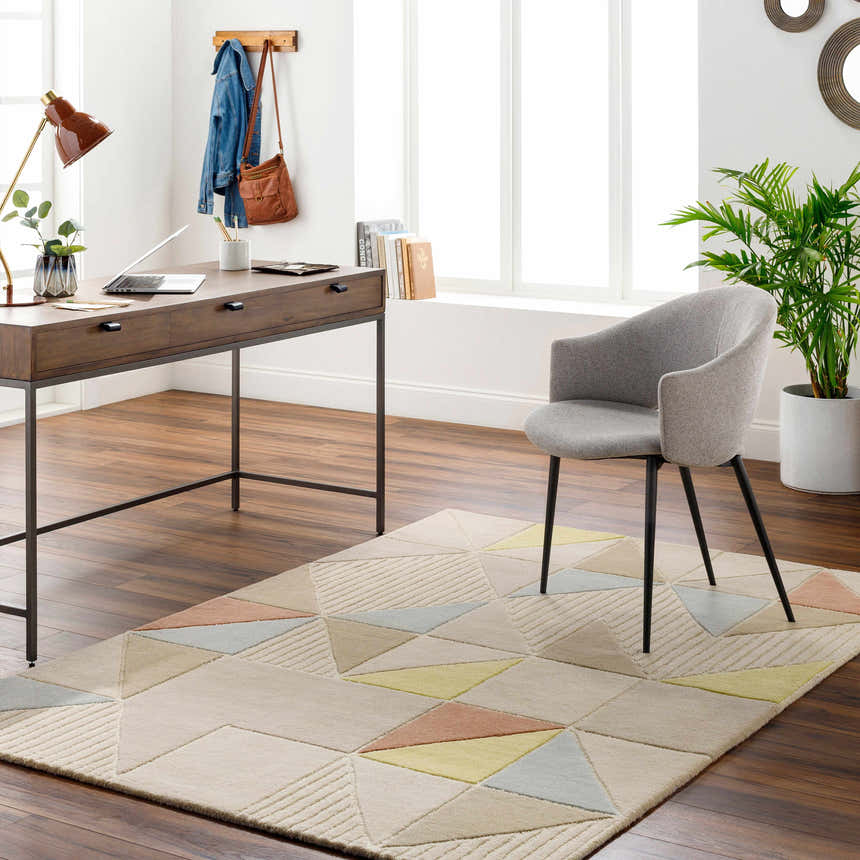 Home office with wood desk, gray chair, and Mani Area Rug. The rug has a geometric design in camel, beige, gray, and oatmeal tones. Roomscene-Rectangle