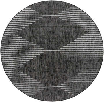 Close-up of round Stephan Area Rug, featuring a black and charcoal woven texture with a cream geometric pattern. Design-Round-67