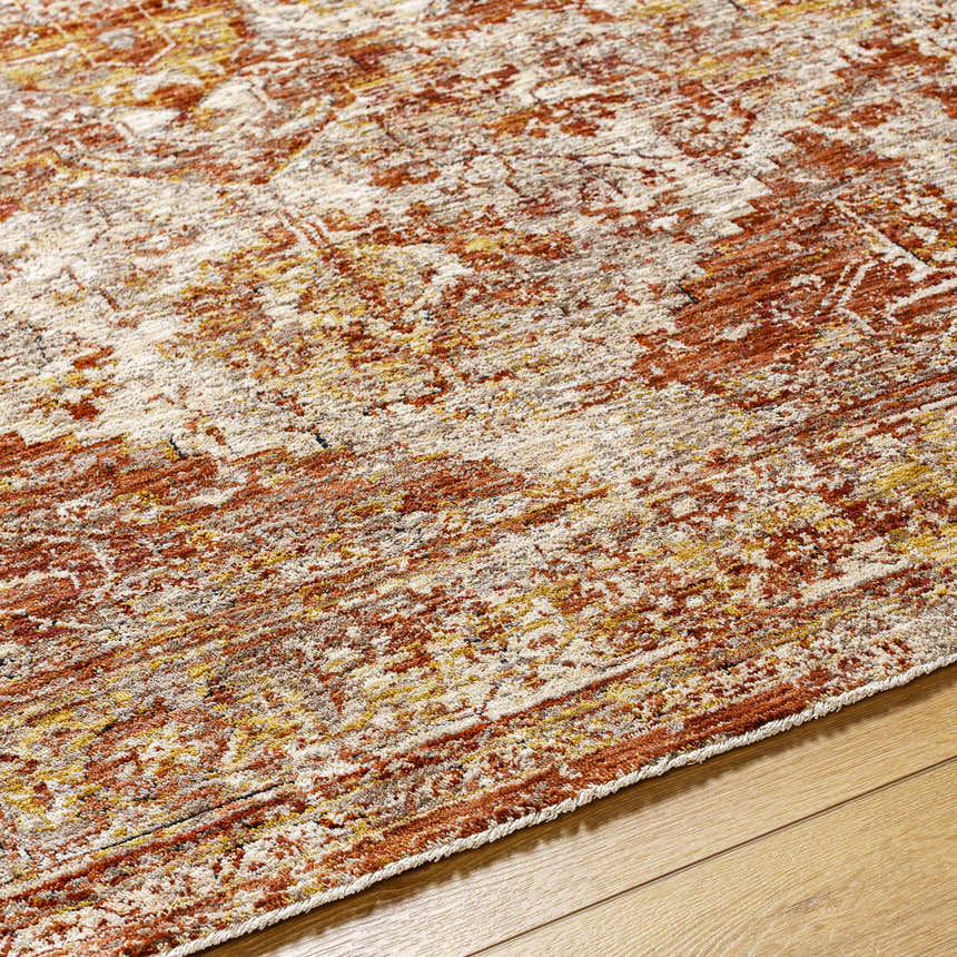 Close-up of the Strathbogie Traditional Red Area Rug showing its brick red, cream, and mustard bohemian pattern. Texture