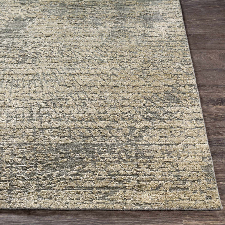 Close-up of the beige and gray Streatley Area Rug showing its textured, contemporary design on dark wood floors. Front