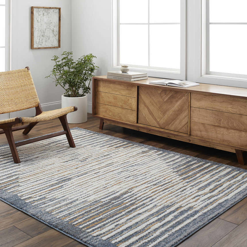 Living room scene with a gray and smoke Kylar Area Rug, wooden chair, and mid-century modern cabinet. Roomscene-Rectangle