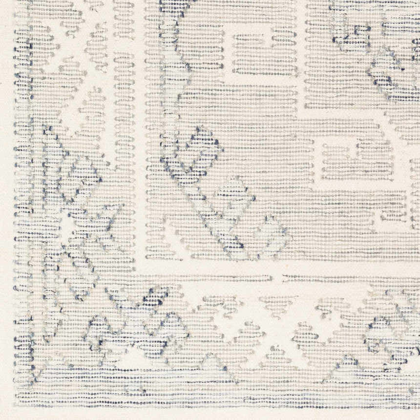 Close up of the hand woven Anund Area Rug showing beige and gray geometric patterns. Swatch