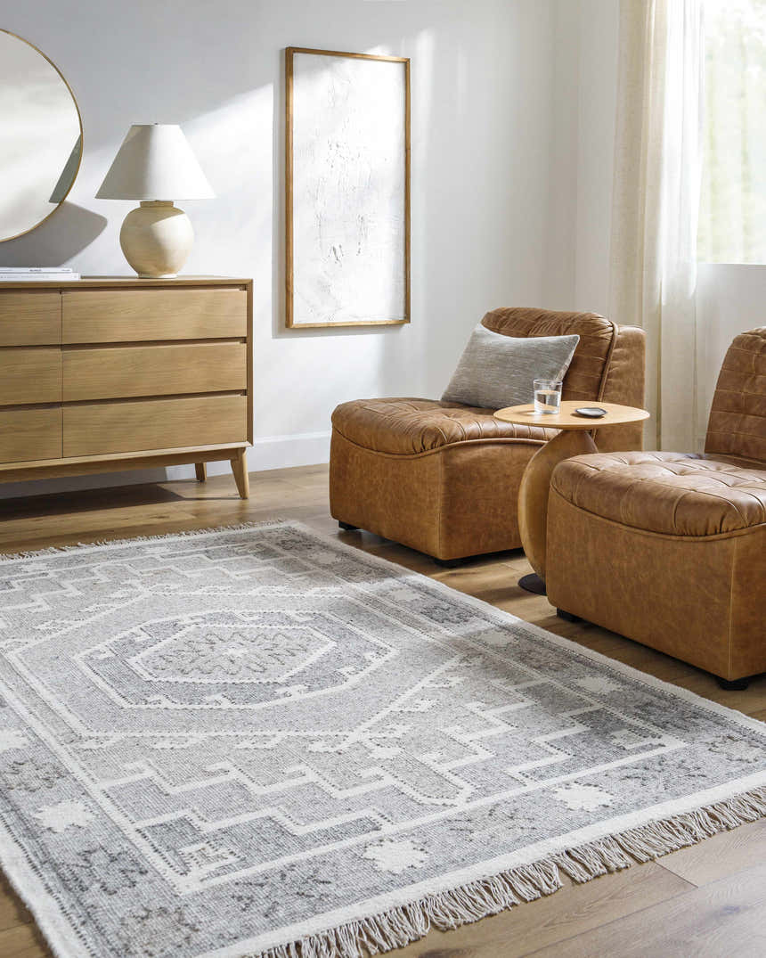 Living room scene with tan leather chairs and a gray and beige Donny Area Rug. Roomscene-Rectangle