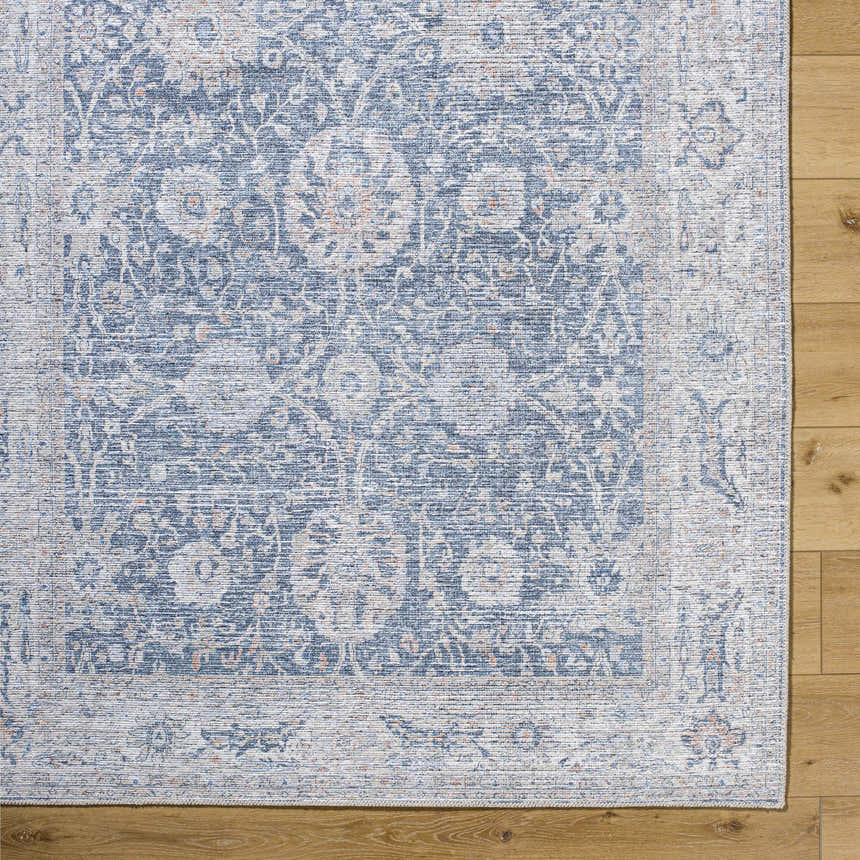 Close-up of the silver and gray Kayin Washable Rug showing its traditional floral pattern and chenille-polyester texture. Corner