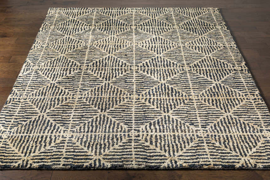 Close-up of Swainsboro Jute Rug. Beige rug with a geometric black pattern. Contemporary style, hand knotted texture. Front