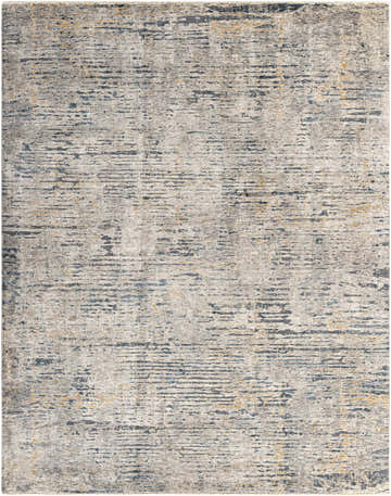 Close-up of the Sywell Luxe Fringe Rug. Beige rug with blue, charcoal, and tan abstract pattern and subtle fringe. Design-Rectangle-710103