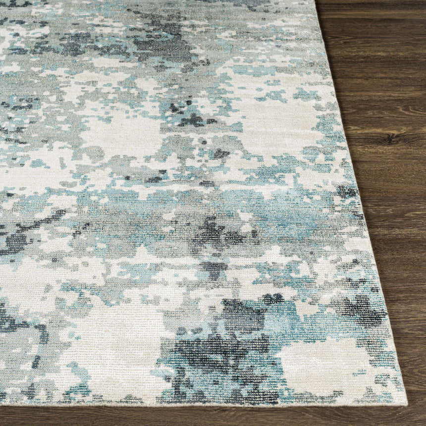 Close-up of Tannersville Area Rug: beige, light beige, sage, and teal contemporary design on a hand-loomed wool and viscose rug. Front