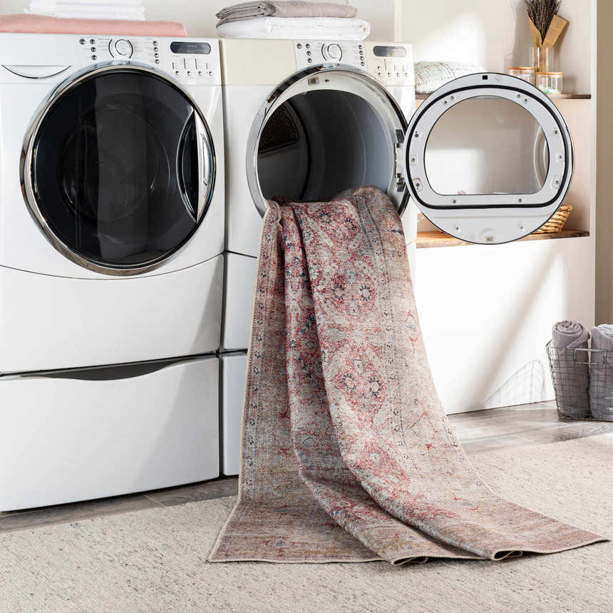 Tapia Washable Area Rug in a laundry room coming out of the dryer, brick red, blue, and gray vintage design. Washing-Machine