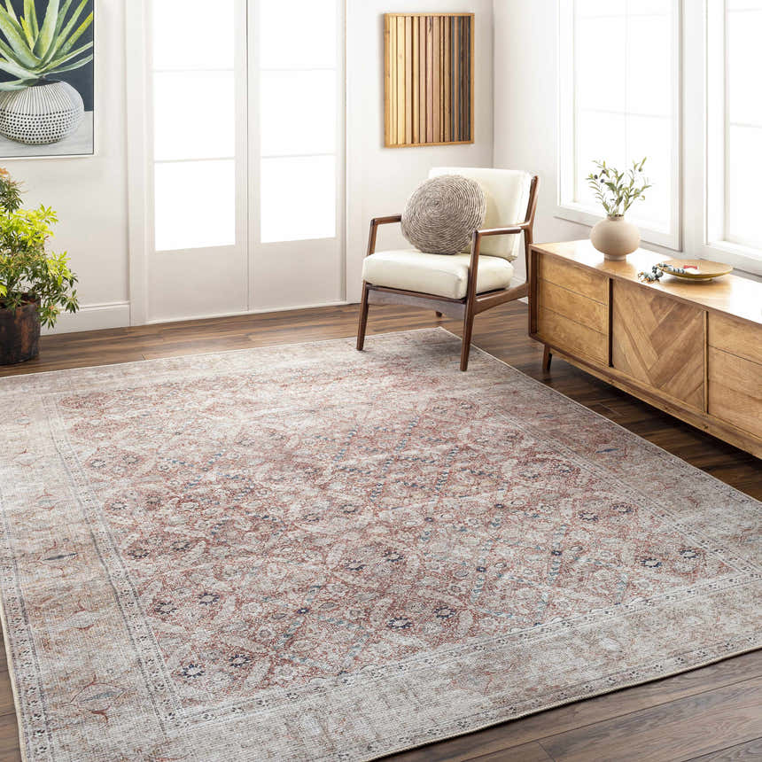 Living room scene with a brick red and dark blue Tapia Washable Area Rug, wood floors, white chair, and wood console table. Roomscene-Rectangle