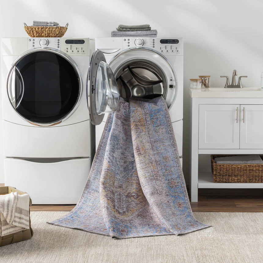 Laundry room scene with Otaki Purple & Brown Washable Area Rug coming out of a front load washing machine. Washing-Machine