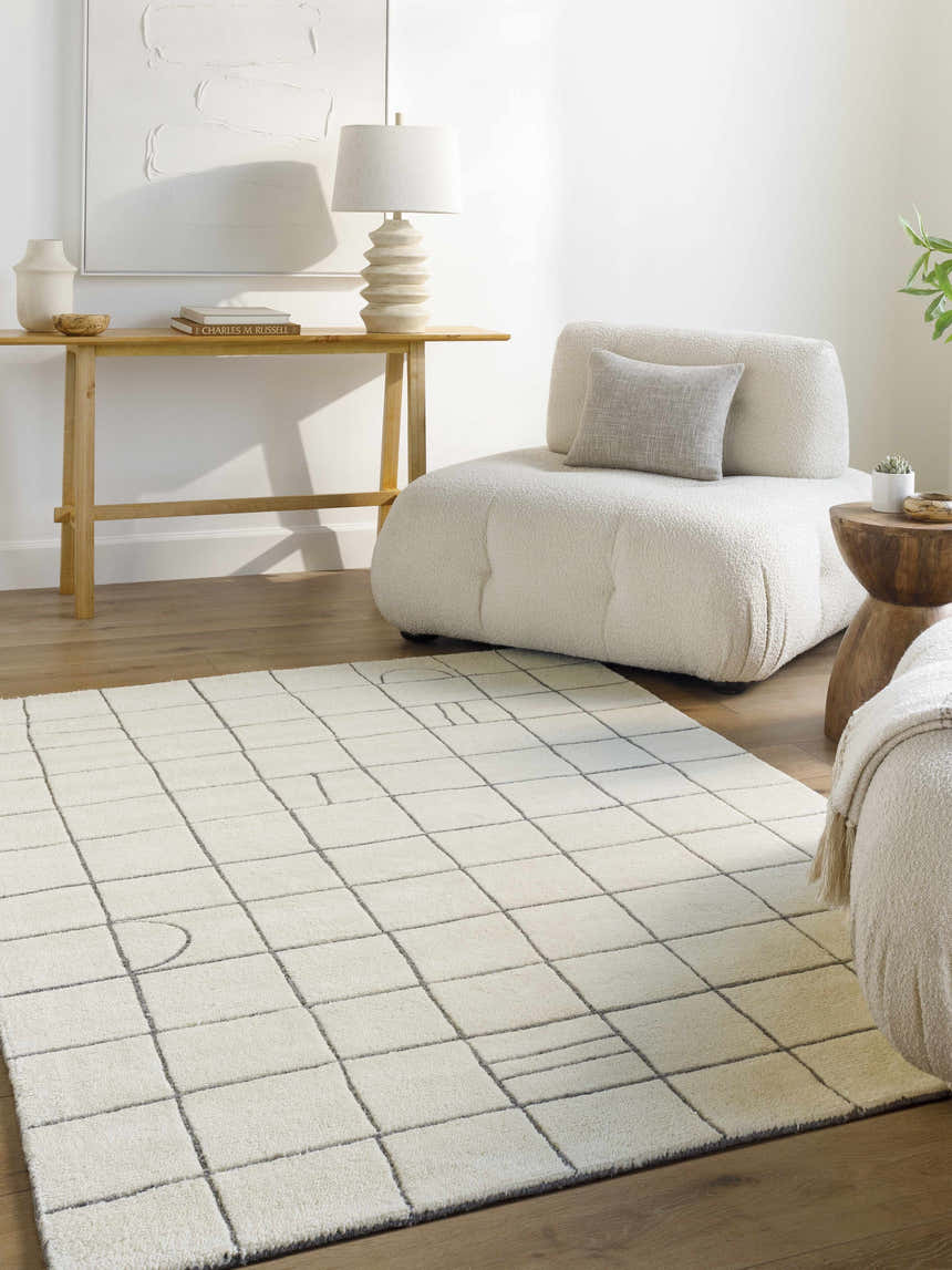Living room scene with Tanya Pearl White Grid Wool Rug, off-white chair, and wood accents. Roomscene-Rectangle