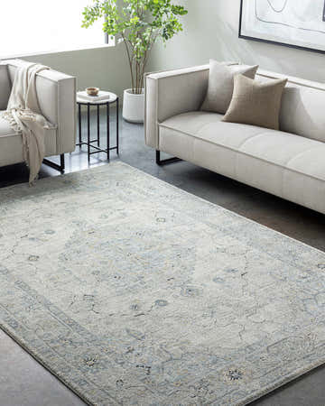 Modern living room with a Tyche Beige Thick Luxe Area Rug, light gray sofas, and minimalist decor. Roomscene-Rectangle