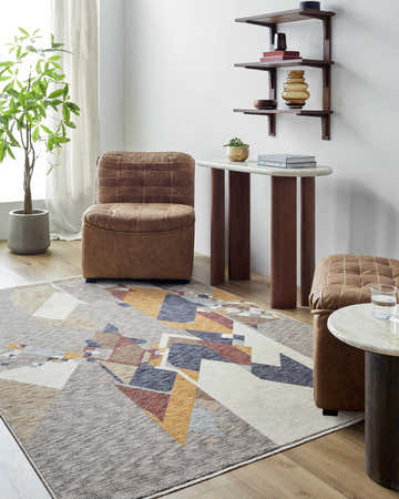 Living room scene with the Timea Area Rug, brown leather chairs, and modern wood shelving. Roomscene-Rectangle