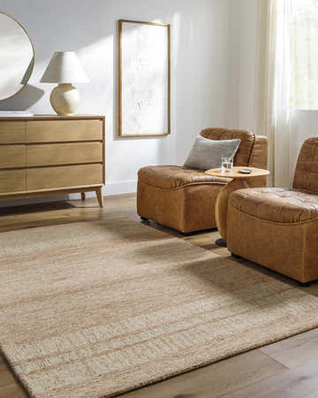 Living room scene with tan Tansy Area Rug, leather chairs, and light wood dresser. Roomscene-Rectangle