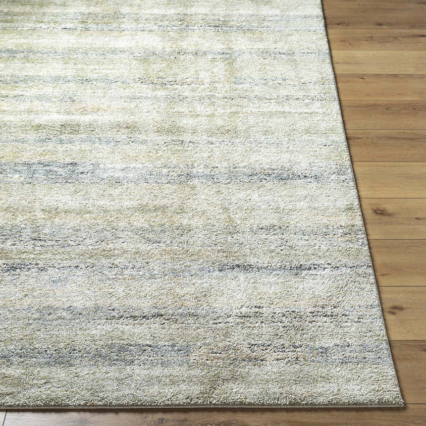 Close-up of Taran Thick Luxe Rug showing light gray, olive, and tan horizontal stripes on a soft, textured pile. Front