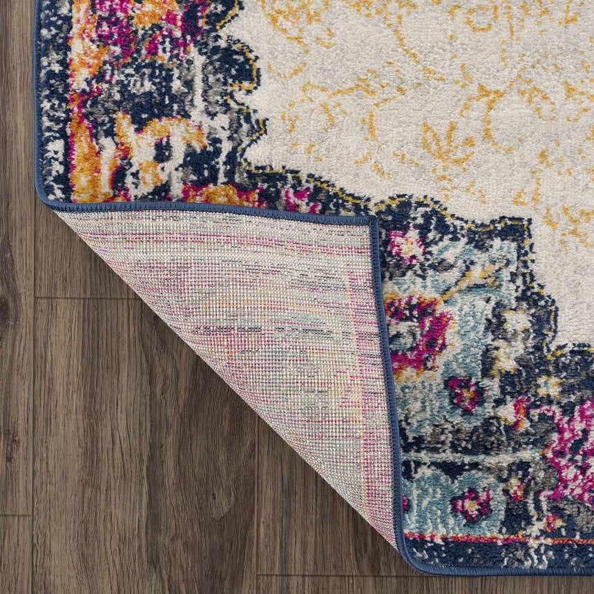 Close-up of the Tigrit Blue & Orange 2300 Area Rug showing its bohemian design, colors, texture, and machine-made construction. Fold