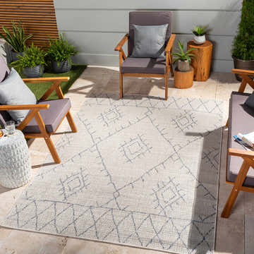 Outdoor patio scene with Marwood Gray&Blue Nordic Rug, wood chairs with gray cushions, and potted plants. Roomscene-Rectangle