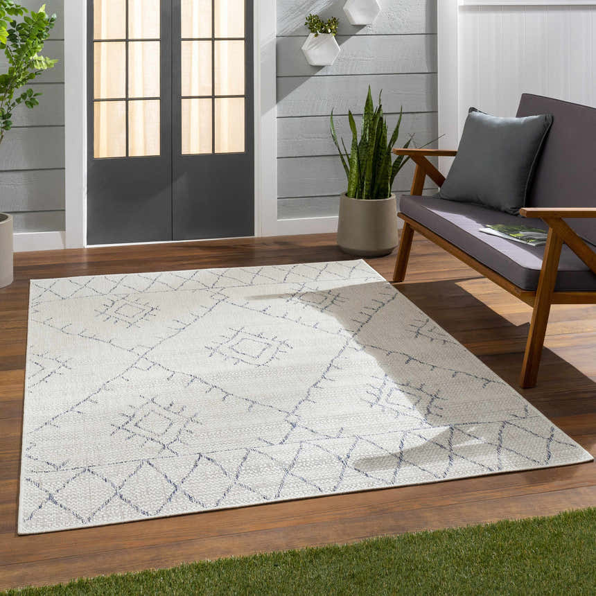 Patio scene with Marwood Gray&Blue Nordic Rug, gray loveseat, wood floors, and gray siding creates a cozy outdoor living space. Roomscene-Rectangle