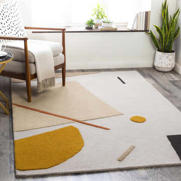 Living room scene with a modern chair and the Townview Wool Area Rug with geometric shapes. Roomscene-Rectangle