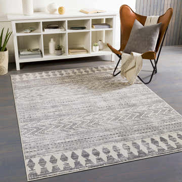 Living room scene with gray Tuy Area Rug, leather chair, white console table, and gray wood floors. Roomscene-Rectangle