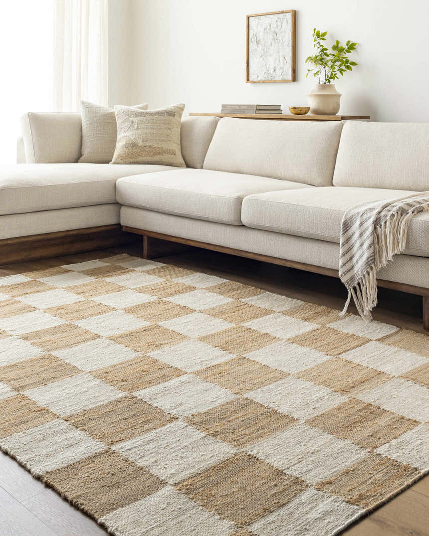 Living room with a neutral sectional sofa and the Tyhir Checkered Jute Rug in light brown and cream. Roomscene-Rectangle