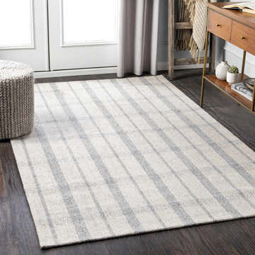 Living room scene with a Verdon Light Gray Plaid Rug, wood console table, and gray knit ottoman. Neutral, transitional style. Roomscene-Rectangle