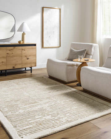 Living room scene with a tan Vanhi Area Rug, light wood floors, and neutral furniture. Roomscene-Rectangle