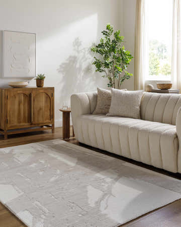 Living room scene with a Viven Ivory Area Rug, cream sofa, wood cabinet, and neutral decor. Roomscene-Rectangle