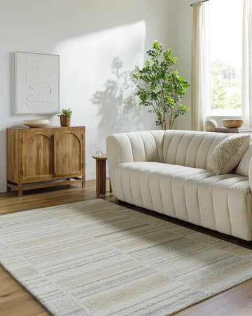 Living room scene with a cream sofa and the ash and light silver Vivek Modern Wool Rug. Roomscene-Rectangle