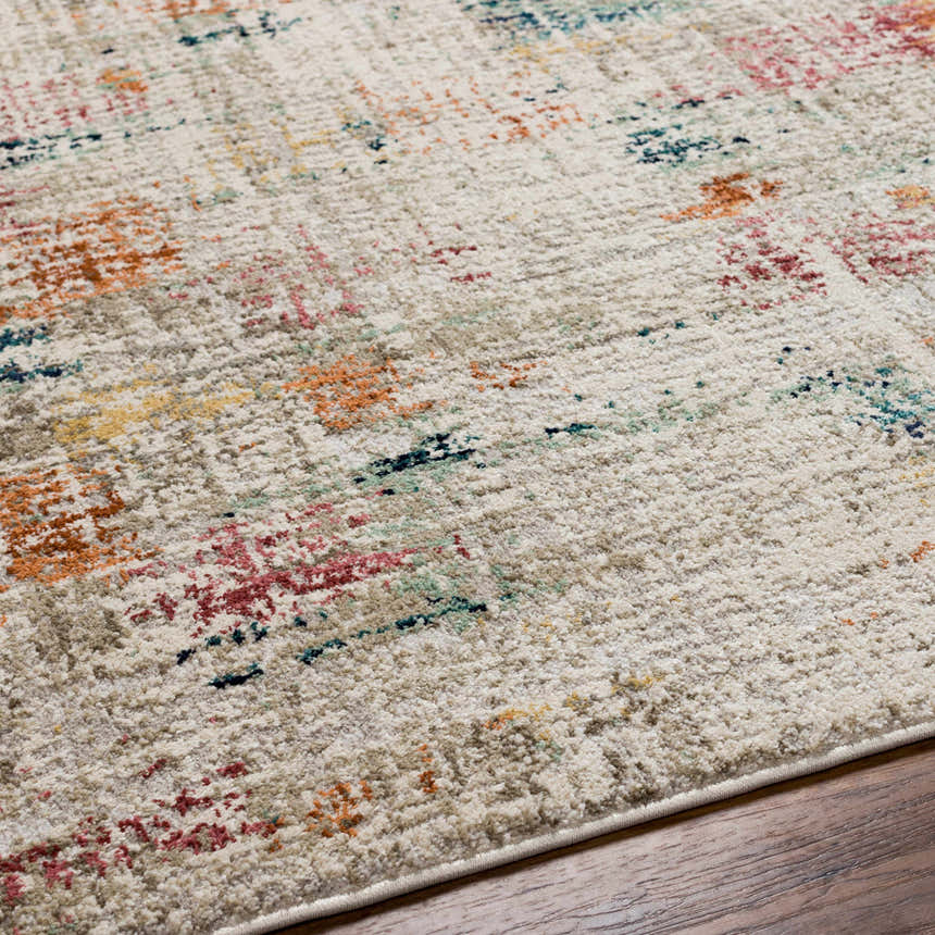 Close-up of the Eversley Area Rug, a cream rug with dark blue, pink, mustard, and gray abstract pattern. Texture