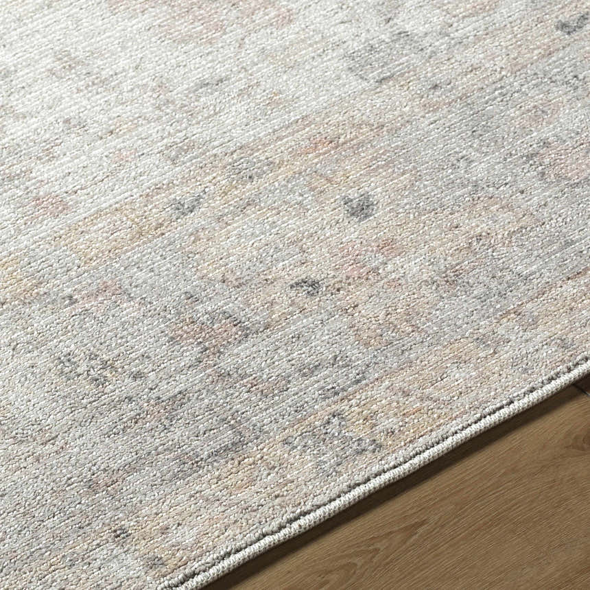 Close-up of Valko Area Rug. Machine woven polyester rug in dusty pink, gray, and tan farmhouse traditional style. Texture
